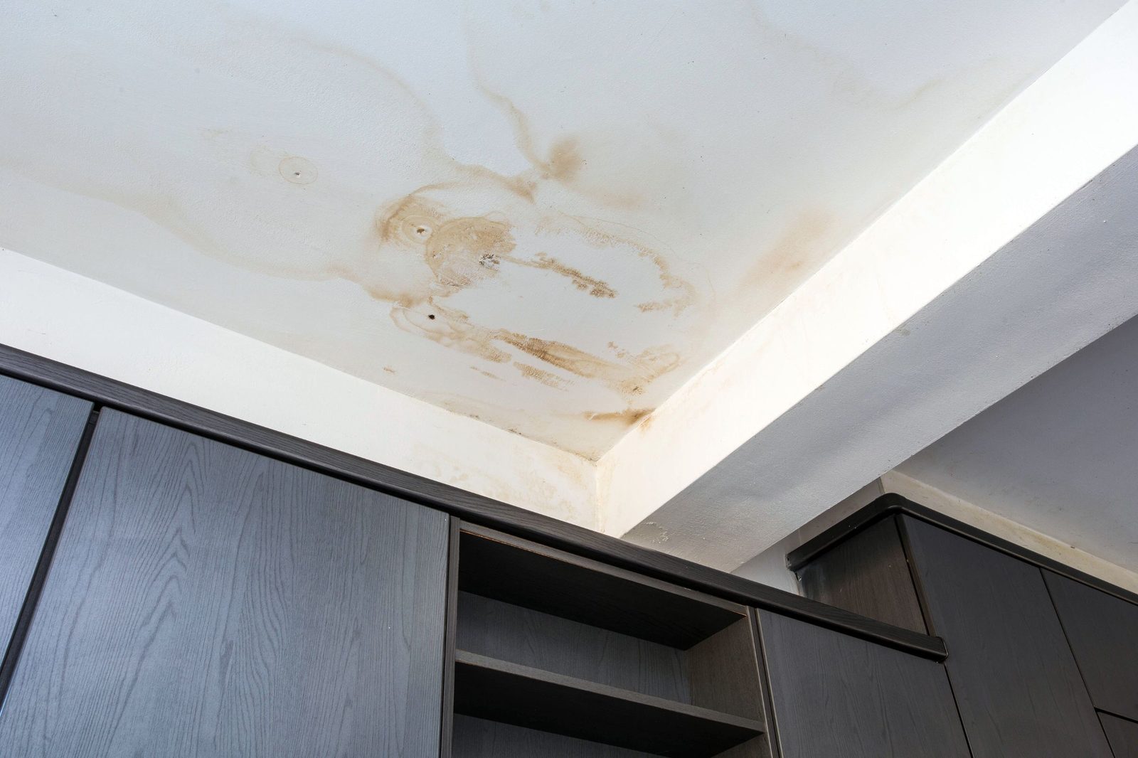 Water-stained ceiling and wall in a residential space
